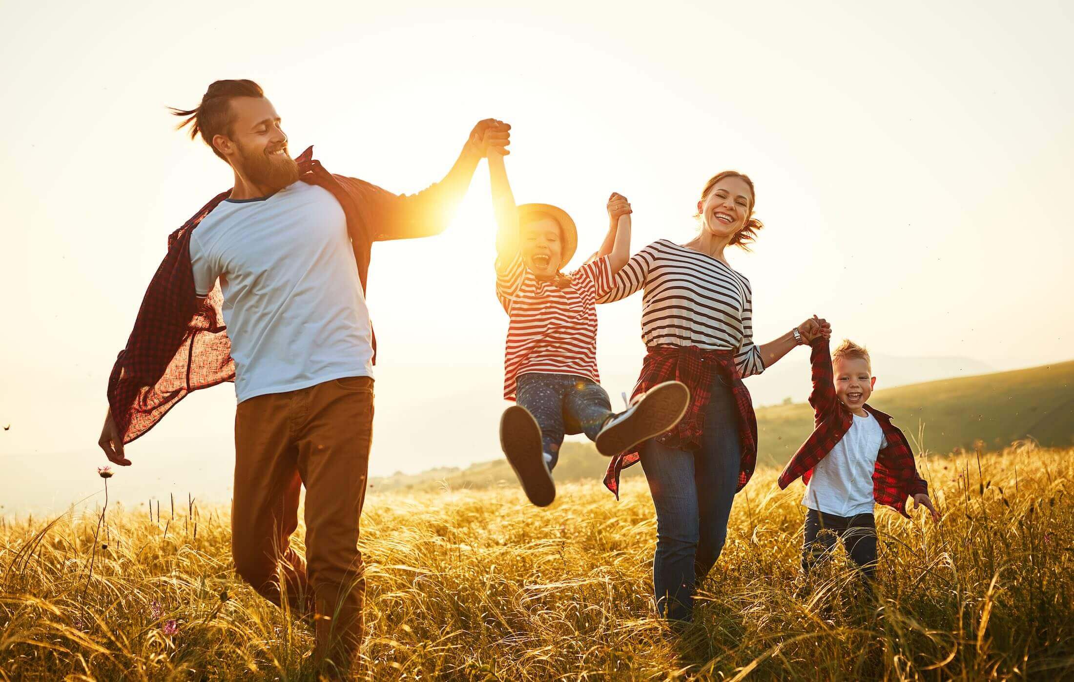 Husband, Wife, and two kids walking together, holding hands